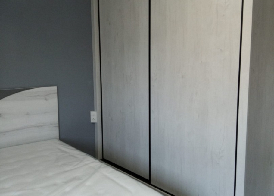 Dormitorio a medida en tonos claros con armario corredero integrado